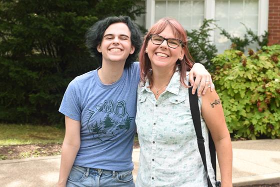 Photo of a Chatham University student and their parent smiling for the camera